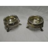 A pair of George III silver circular salts on three hoof feet,