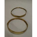 Two various 9ct gold oval bangles with engraved decoration