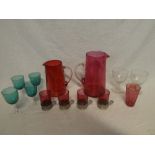 Two cranberry tinted glass tapered jugs,