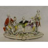 A Continental china group of an interior with two males and two females on oval base,