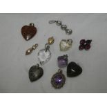 An amethyst mounted oval pendant, various other semi-precious stone pendants,