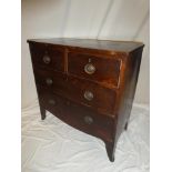 A small 19th Century mahogany chest of two short and two long drawers with brass ring handles on