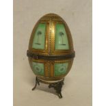 A 19th Century china oval jar and cover with gilt and painted decoration and brass mounted rim and
