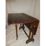 A Victorian walnut Sutherland-style drop leaf tea table on turned legs