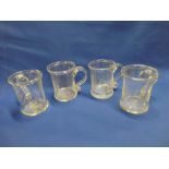 Four 19th Century glass pint sized tankards with etched decoration and scroll handles