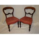 A set of four Victorian mahogany balloon back dining chairs with carved rail backs and upholstered