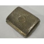 A silver rectangular cigarette case with beaten decoration,