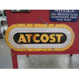 An enamel sign - Atcost,