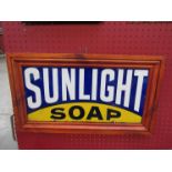 A framed enamel sign: Sunlight Soap, 21" x 12" including frame,