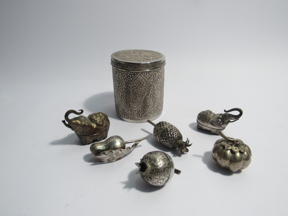 A Kashmiri or Indian silver drum shaped box with lid together with six Cambodian small silver boxes