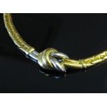 A two tone gold necklace with knot design, stamped 750,