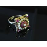 A gold ring split pearl and rubies in square mount, stamped 9ct, size S,