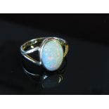 A 9ct gold ring set with an oval opal in split shoulders, size L, 2.