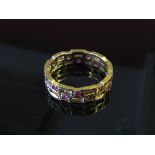 A 9ct gold pierced band set with rubies, size R, 3.