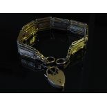 A gold gate link bracelet with padlock, stamped 9ct,