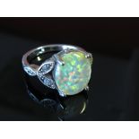 A dress ring opal style with white stones,