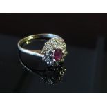 A 9ct gold ruby and diamond cluster ring, size P, 2.