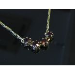 A 9ct gold four stone garnet necklace, 3.