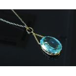 A blue synthetic sapphire pendant on chain,