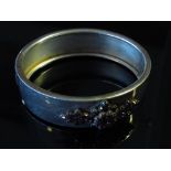 A stiff hinge bangle set with garnets,