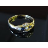 An 18ct gold ring three seed pearls separated by sapphires edged with six small diamonds, size L/M,