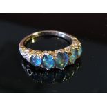 A 9ct rose gold blue opal five stone ring, size M, 2.