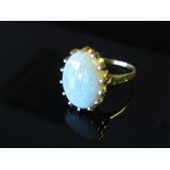 An opal cabochon ring in claw set mount, size Q, 5.