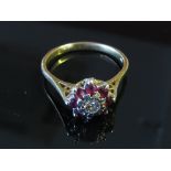 A gold diamond and ruby cluster ring, marks rubbed, size S,