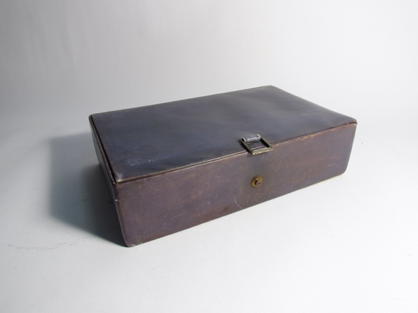 A leather jewellery box with buckle contents