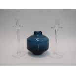 A Wedgwood vase in midnight blue and two clear candlesticks