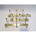 Three brass coloureed metal wall hanging coat racks