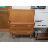 A Danish oak finish bureau, single shelf interior, three drawers below. Raised on tapering legs.