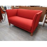 A Danish 1940's twin seater sofa, original red wool upholstery, short square stained oak legs,