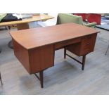 A Danish teak twin pedestal desk, three drawers and single door flanking single drawer,