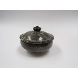 An Abuja Pottery lidded pot with grey ash glaze and incised line detail.