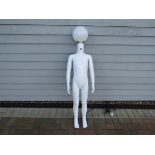 A perspex mannequin figure with globe light head,