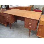 A Danish teak twin pedestal desk with six drawers, open shelf back, raised on tapering legs,
