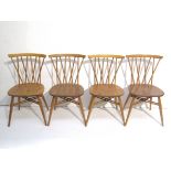 A set of four Ercol Chiltern Candlestick chairs in light elm and beech