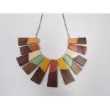 An unusual contemporary collar necklace with teak wood and pastel tone lucite