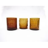 Three Bengt Edenfalk amber glass canisters,