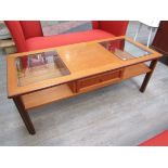 A G-Plan teak coffee table with two inset glass panels and single drawer. 121.