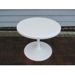 A white circular glass fibre table