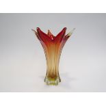 An art glass vase in red and amber with six point star rim,
