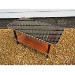 A 1960's coffee table, black perspex top with lined detail,