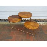A Mid Century wood and metal three tiered circular disc display stand,