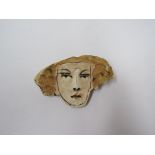CHRISTY KEENEY (b.1958): A studio pottery brooch featuring the image of a girl's face, 4.