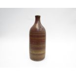 PETER LANE (b.1932): An early stoneware bottle vase with reddish ash glaze.