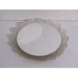 A textured Lucite framed circular illuminating wall mirror, 42.