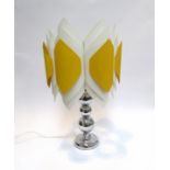 A chromed metal lamp base with a white and yellow plastic shade.