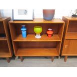 A Danish teak open bookcase raised on tapering legs,